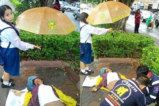 Cảm phục nữ sinh tiểu học đứng dầm mưa che ô cho người gặp nạn 