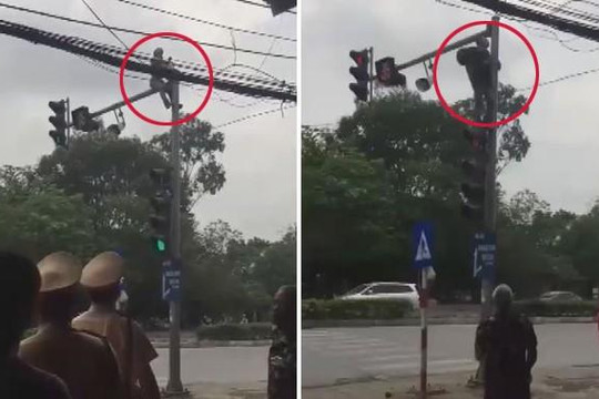 Nam thanh niên leo lên cột đèn giao thông ăn vạ vì bị CSGT thu xe