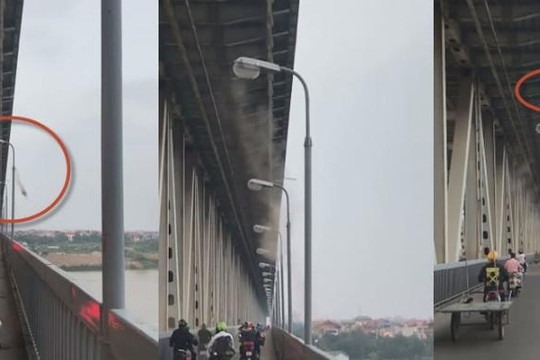 Clip hàng trăm người đi xe máy qua cầu Thăng Long bị hất cát trúng mặt