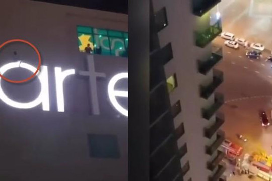Đập cửa kính, ngồi vắt vẻo trên logo ngoài khách sạn Ala Carte Đà Nẵng ở tầng 20 