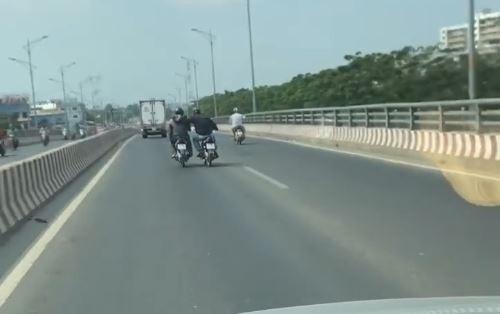 Thót tim cảnh 2 người đi xe máy khoác vai nhau chạy trên làn ô tô