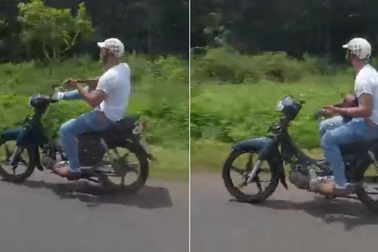 Clip chàng trai dùng 2 tay chơi guitar khi chạy xe máy: Bị phạt bao nhiêu?